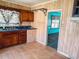 View of a kitchen with wood cabinets, a blue countertop, and access to another room at 422 S Magnolia Ave., Andrews, SC 29510