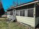 Enclosed sunroom with screened windows providing natural light, and a view of the yard at 422 S Magnolia Ave., Andrews, SC 29510