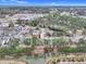 An aerial view of a charming condo community surrounded by lush green trees and a serene waterfront view at 4257 Villas Dr. # 106, Little River, SC 29566
