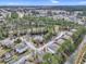 An aerial photograph showcasing a condo community nestled within a natural setting, complete with a pond at 4257 Villas Dr. # 106, Little River, SC 29566