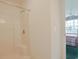 Bathroom with standard shower and view into the bedroom at 4257 Villas Dr. # 106, Little River, SC 29566
