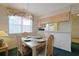 Cozy dining area with seating for four and adjacent kitchen at 4257 Villas Dr. # 106, Little River, SC 29566
