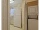 The kitchen is located next to a laundry closet with stacked units at 4257 Villas Dr. # 106, Little River, SC 29566