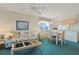 Open living area with a floral sofa and dining set at 4257 Villas Dr. # 106, Little River, SC 29566