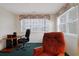 Bright office space featuring large windows, a desk, and a comfortable chair at 4257 Villas Dr. # 106, Little River, SC 29566