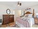 Cozy primary bedroom with wood accents, dresser, ceiling fan, and soft decor at 4448 Lady Banks Ln. # 11E, Murrells Inlet, SC 29576