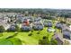 Aerial view showcasing a condo building with community pool, set against a golf course and lush landscaping at 4701 Wild Iris Dr. # 16-204, Myrtle Beach, SC 29577