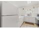 Bright kitchen with white cabinets, countertops and stainless steel appliances at 4701 Wild Iris Dr. # 16-204, Myrtle Beach, SC 29577
