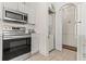 A well-equipped kitchen featuring stainless steel appliances and stacked washer/dryer at 4701 Wild Iris Dr. # 16-204, Myrtle Beach, SC 29577