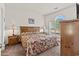 Comfortable main bedroom showcasing a large bed, arched window, and wood furnishings at 4701 Wild Iris Dr. # 16-204, Myrtle Beach, SC 29577