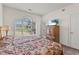 Comfortable bedroom showcasing a golf course view from a large arched window at 4701 Wild Iris Dr. # 16-204, Myrtle Beach, SC 29577