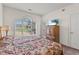 Bright main bedroom offering natural light, floral bedding, and a view of the golf course at 4701 Wild Iris Dr. # 16-204, Myrtle Beach, SC 29577