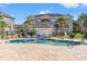 Community pool area with lounge chairs and well-maintained landscaping, set against a blue sky backdrop at 4701 Wild Iris Dr. # 16-204, Myrtle Beach, SC 29577