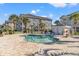 Community pool area with lounge chairs and well-maintained landscaping and nearby condos at 4701 Wild Iris Dr. # 16-204, Myrtle Beach, SC 29577