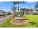 Exterior shot of Magnolia Place community sign with well-maintained landscaping and nearby condos at 4701 Wild Iris Dr. # 16-204, Myrtle Beach, SC 29577
