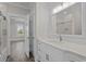 Modern bathroom with dual sinks, white cabinetry and shower at 4843 Williams Island Dr., Little River, SC 29566