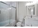 Bright bathroom featuring subway tile, glass enclosed tub, and updated vanity at 4843 Williams Island Dr., Little River, SC 29566