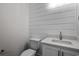 Elegant half-bathroom featuring shiplap walls and a modern vanity at 4843 Williams Island Dr., Little River, SC 29566