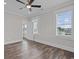 Bedroom features wood floors, a ceiling fan, and natural light at 4843 Williams Island Dr., Little River, SC 29566