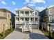 Stunning two-story coastal home featuring double balconies and a grand entrance staircase at 4843 Williams Island Dr., Little River, SC 29566