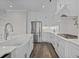 Modern kitchen with white cabinets, stainless steel appliances, and marble countertops at 4843 Williams Island Dr., Little River, SC 29566