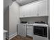 Functional laundry room with white cabinets and modern washer and dryer at 4843 Williams Island Dr., Little River, SC 29566