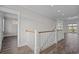 Bright stairway showcasing wood floors and white banisters at 4843 Williams Island Dr., Little River, SC 29566
