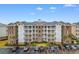 Well-maintained multi-story building with brick facade, balconies, and landscaped surroundings at 4875 Luster Leaf Circle # 202, Myrtle Beach, SC 29577