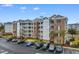 Beautiful condo complex featuring brick accents, multiple balconies, and ample parking at 4875 Luster Leaf Circle # 202, Myrtle Beach, SC 29577