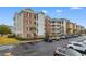 Attractive multi-story building with brick accents, white railings, and ample parking space at 4875 Luster Leaf Circle # 202, Myrtle Beach, SC 29577
