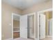 Hallway with multiple doors leading to various rooms and a linen closet with mirrored doors at 4875 Luster Leaf Circle # 202, Myrtle Beach, SC 29577