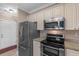Bright kitchen featuring stainless steel appliances, light cabinetry, and ample counter space at 4875 Luster Leaf Circle # 202, Myrtle Beach, SC 29577