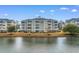 Picturesque waterfront views with multi-story buildings, serene water, and open green spaces at 4875 Luster Leaf Circle # 202, Myrtle Beach, SC 29577