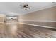 Open-concept living room with hardwood floors, neutral paint, and a ceiling fan at 4875 Luster Leaf Circle # 202, Myrtle Beach, SC 29577