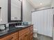 Bathroom featuring a modern vanity, dark wood framed mirror, and a shower with curtain at 489 Harbour View Dr., Myrtle Beach, SC 29579