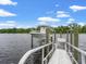 Waterfront home featuring a private boat lift with boat, dock, and scenic water views at 489 Harbour View Dr., Myrtle Beach, SC 29579