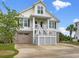 Inviting two-story home featuring a charming front porch and a two-car garage at 489 Harbour View Dr., Myrtle Beach, SC 29579