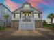 Charming two-story home with a double garage and a quaint front porch at sunset at 489 Harbour View Dr., Myrtle Beach, SC 29579