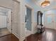 Inviting foyer featuring wood floors, coat rack with mirror, and views into the bathroom and bedroom at 489 Harbour View Dr., Myrtle Beach, SC 29579