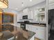 Well-equipped kitchen with granite countertops, black appliances, and ample storage at 489 Harbour View Dr., Myrtle Beach, SC 29579