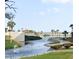 Scenic view of a community park with a tranquil waterway, lush landscaping, and walking paths to the beach at 490 Ocean Creek Dr. # 8, Myrtle Beach, SC 29572