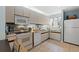 A cozy kitchen featuring white appliances, tan cabinets and tile floors at 490 Ocean Creek Dr. # 8, Myrtle Beach, SC 29572