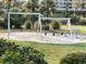 Community playground with swings and sandy play area surrounded by mature trees and landscaping at 490 Ocean Creek Dr. # 8, Myrtle Beach, SC 29572