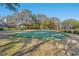 Well-manicured putting green surrounded by mature trees and landscaping offering a peaceful outdoor space at 490 Ocean Creek Dr. # 8, Myrtle Beach, SC 29572