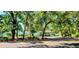 View of the tennis courts with lush landscaping, mature trees and a charming clubhouse in a serene setting at 490 Ocean Creek Dr. # 8, Myrtle Beach, SC 29572