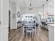 Elegant dining room with stylish lighting, wood floors, and views into a spacious living area; perfect for entertaining at 500 Canborough Lane, Murrells Inlet, SC 29576