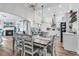 Dining area flows to kitchen, with wood floors, modern lighting, and views of fireplace, perfect for gatherings at 500 Canborough Lane, Murrells Inlet, SC 29576