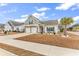 Beautiful home with a two-car garage, complemented by a palm tree and manicured lawn at 500 Canborough Lane, Murrells Inlet, SC 29576