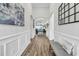 Elegant foyer with wood flooring, wainscoting, arched doorways, and stylish decor at 500 Canborough Lane, Murrells Inlet, SC 29576
