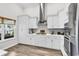 Modern kitchen with stainless steel appliances, white cabinets, sleek countertops, and herringbone tile backsplash at 500 Canborough Lane, Murrells Inlet, SC 29576